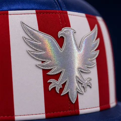 Close-up of the silver glitter eagle on the striped front of the Signature Crown